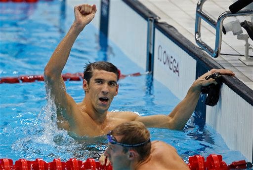 Michael Phelps celebrates after winning the 17th gold medal of his historical Olympics career in Friday's men's 100-meter butterfly.