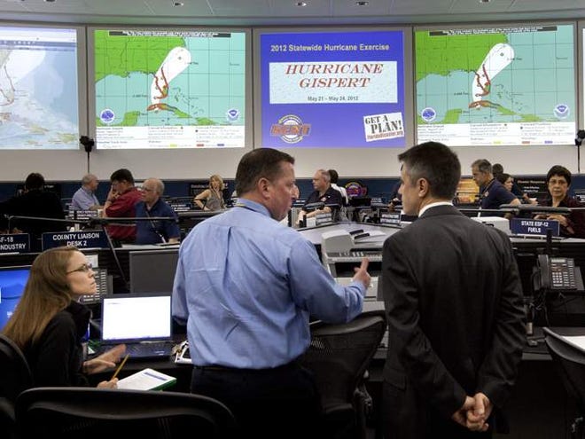 State Emergency Response Team Leader members work during "Hurricane Gispert" a training exercise at the State Emergency Operations Center, Monday in Tallahassee. Hurricane Gispert is a simulated Category 4 hurricane that strikes Tampa during the Republican National Convention. (Sarasota Herald-Tribune/Colin Hackley)