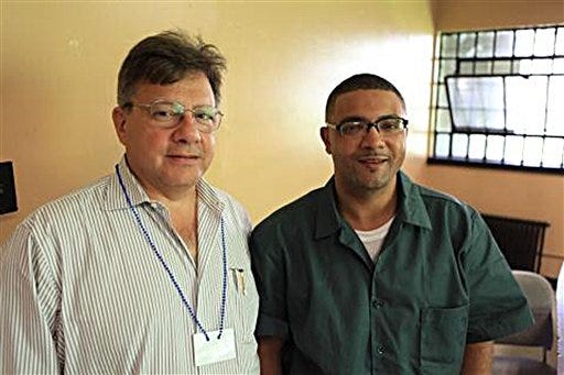 This Wednesday, Aug. 1, 2012 photo provided by attorney Peter Cross shows Cross, left, posing while on a visit with his client Eric Glisson at New York's Sing Sing prison. Glisson was convicted in the 1995 killing of a livery cab driver in New York City but a review of new evidence points to a wrongful murder conviction. (AP Photo/Peter Cross)