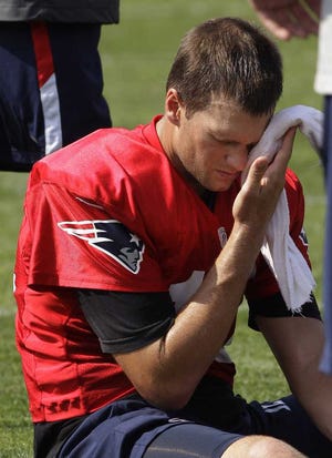 Stephan Savoia Associated Press New England Patriots quarterback Tom Brady wipes his brow after practice Thursday.