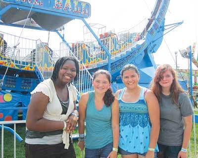 Photo by Brittany Soda/New Jersey Herald - After making it off the Fire Ball alive, Gersie Domond, 13, Madeline Menna Bell, 14, Ariel Cifuentes, 14, and Delsea Albanese, 14, smile at the New Jersey State Fair/Sussex County Farm and Horse Show.