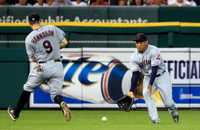 Cleveland Indians left fielder Ezequiel Carrera, right, and third baseman Jack Hannahan (9) misplay a single by Detroit Tigers' Prince Fielder during the sixth inning of a baseball game in Detroit, Friday, Aug. 3, 2012.