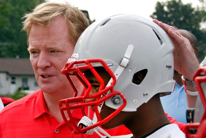 NFL commissioner Roger Goodell, left, poses with Jaqueal Hitchcock, 14, from the Akron Parents Pee Wee Football League in Akron.