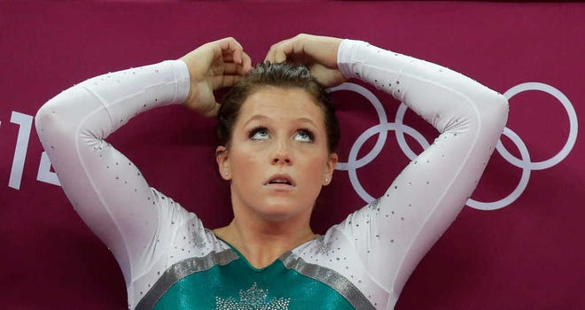 Canadian gymnast Brittany Rogers looks at the scoreboard after a performance during the artistic gymnastics women's vault finals at the 2012 Summer Olympics, Sunday, Aug. 5, 2012, in London. (AP Photo/Julie Jacobson)