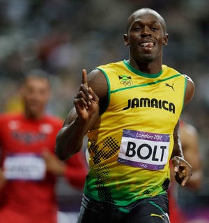 Jamaica's Usain Bolt celebrates after winning the men's 100-meter during the athletics in the Olympic Stadium at the 2012 Summer Olympics, London, Sunday, Aug. 5, 2012. (AP Photo/Marcio Jose Sanchez)