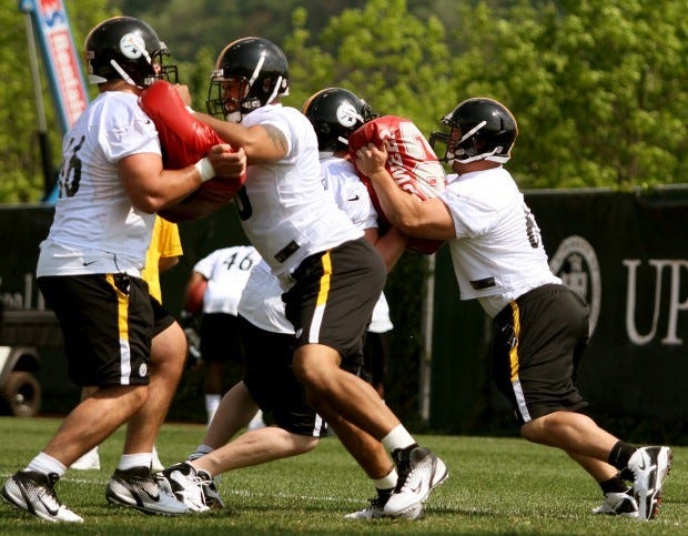 First-round draft pick David DeCastro, left, goes through a drill with second-round draft pick Mike Adams during rookie mini-camp in May.