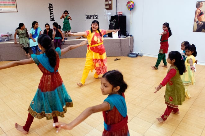 Teacher Rama Suresh goes over some of the intricate moves of classical Indian dance with her pupils during a recent session at Jazzercise, 7010A North University Street in Peoria.