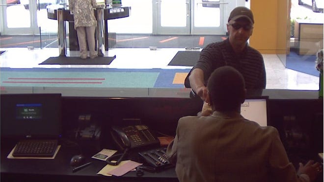 The man had handed the teller a note demanding money, which he put in a light blue backpack.
