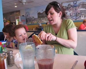 In this March 20, 2012, photo, Sarah Lee butters a bagel for her 2/12-year-old son Jack in a restaurant in Ocean City, N.J. Lee plans to vote in May against a proposal to let restaurant patrons in Ocean City bring their own beer or wine to have with dinner, saying she wants to preserve the family-friendly atmosphere of the seaside resort town. (AP Photo/Wayne Parry)