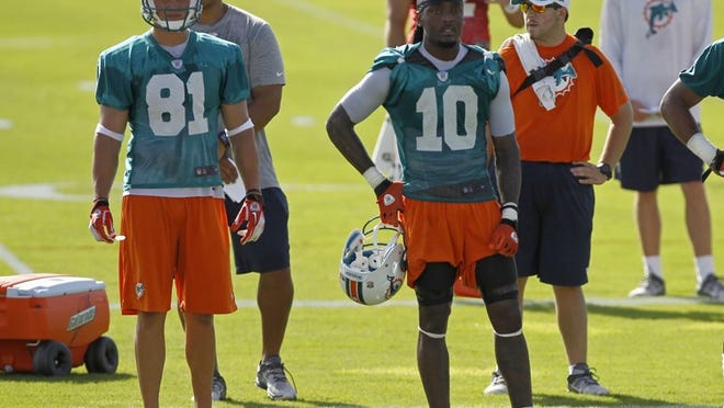 Miami Dolphins' Clyde Gates (10) and Chris Hogan (81) watch during NFL football training camp practice in Davie, Fla., Friday, July 27, 2012. (AP Photo/Alan Diaz)