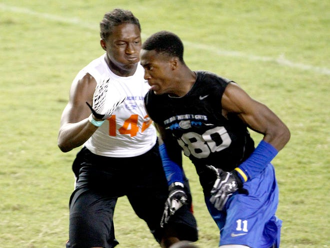 Defensive back Duke Dawson, left, defends on a passing drill during Friday Night Lights at Ben Hill Griffin Stadium on July 27.