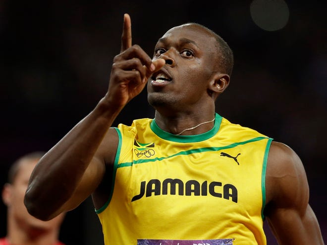 Jamaica's Usain Bolt holds up one finger after finishing first in the men's 100-meter final during the athletics in the Olympic Stadium at the 2012 Summer Olympics in London on Sunday. (AP Photo/Anja Niedringhaus)