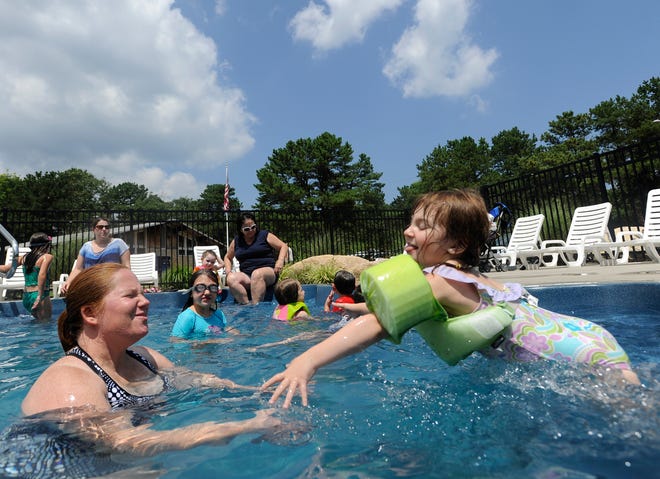 Tracey Fraise of North Attleboro catches her daughter Kelsea, 3, as she leaps into the Bourne Scenic Park pool on Monday, July 16, 2012. The pool was brimming with children and adults seeking refuge from the hot weather. This is the hottest year on record in the Northeast, according to data released Tuesday, Aug. 7, 2012 by the Northeast Regional Climate Center in Ithaca, N.Y.