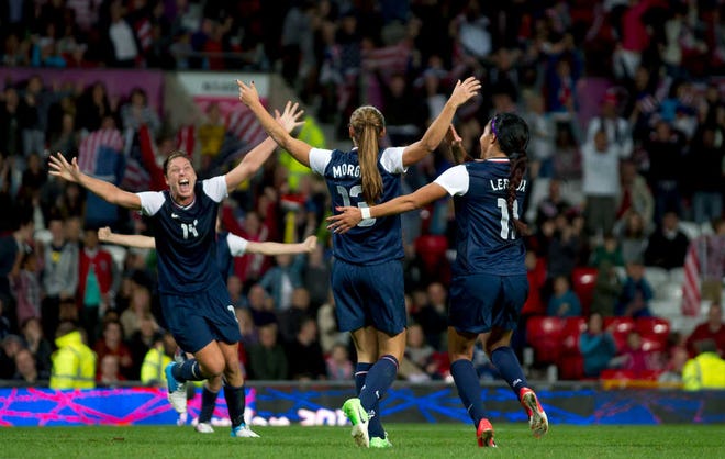 The United States' Alex Morgan, center, celebrates with teammates including Sydney Leroux, right, after Morgan scored the decisive goal in a 4-3 win against Canada in an Olympic semifinal match on Monday in Manchester, England.