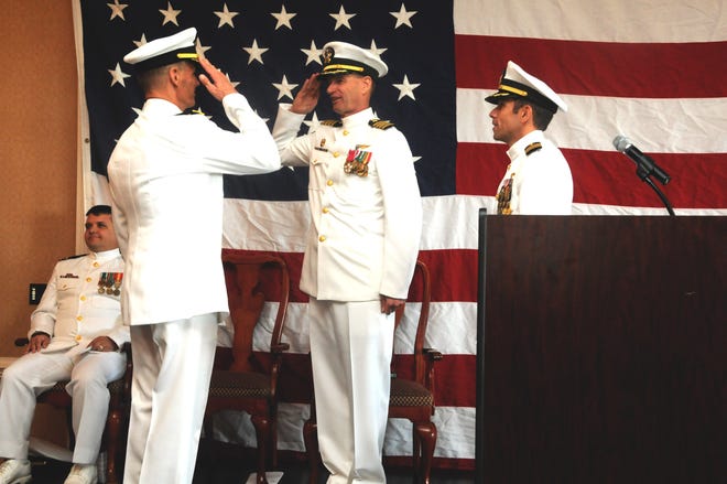 Capt. Daniel Boyles salutes guest speaker Rear Adm. Ted Branch, Commander, Naval Air Force Atlantic, after relieving Capt. Douglas ten Hoopen as Commander, Helicopter Maritime Strike Wing, U.S. Atlantic Fleet on Aug. 3 during a ceremony at Ocean Breeze Conference Center.
