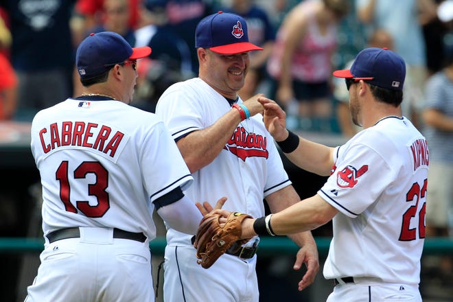 Cleveland Indians manager Manny Acta (center) smiles as he congratulates Asdrubal Cabrera (left) and Jason Kipnis after the Indians defeated the Minnesota Twins 6-2 on Wednesday in Cleveland.