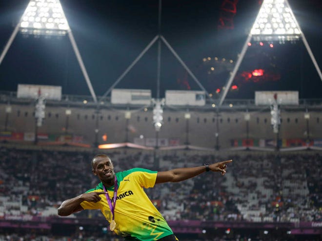 Jamaica's Usain Bolt celebrates winning the gold during the ceremony for the men's 200-meter final during athletics in Olympic Stadium at the 2012 Summer Olympics, Thursday, Aug. 9, 2012, in London. (AP Photo/Matt Slocum)