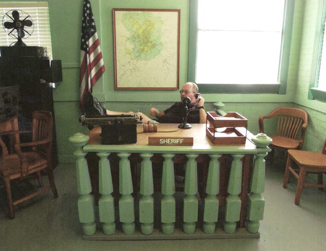 Retired Knox County Sheriff's Deputy and Elmwood resident Tom Morse sits behind the sheriff's desk in the "Mayberry Courthouse in Mount Airy, N.C.