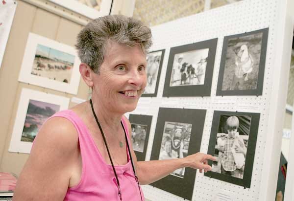 Photo by Daniel Freel/New Jersey Herald Former New Jersey Herald Chief Photographer Anna Murphey talks on Tuesday about some of her favorite fair photos that she has shot over her career that are on display in the Richards Building of the fair.