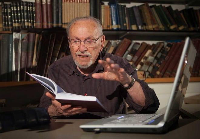 Biblical scholar Professor Menachem Cohen reads a book at the library of Bar Ilan University, outside Tel Aviv, Israel. For the past 30 years, the 84-year-old has been immersed in the task of correcting all known errors in Jewish Scripture to produce a definitive edition of the Hebrew Bible. Now, thanks to the Internet, he's bringing it to the general public with a sophisticated search engine that allows even novices to explore the holy text with ease.