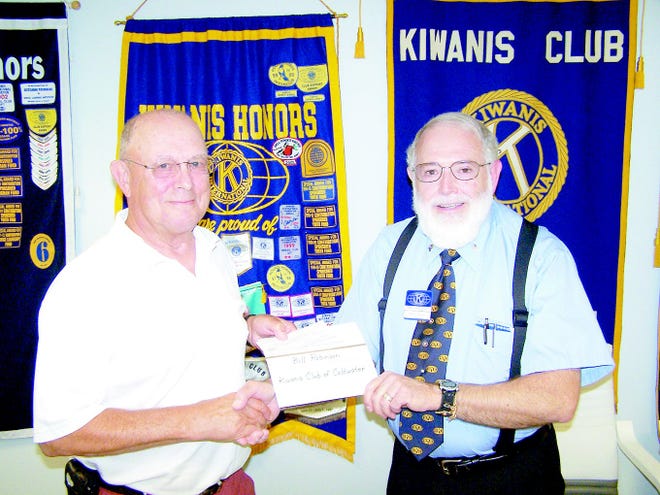 Kiwanis President Terry Tomlinson presents Mary and Martha’s Diner volunteer Bill Robinson with a $200 check to assist with meal costs.