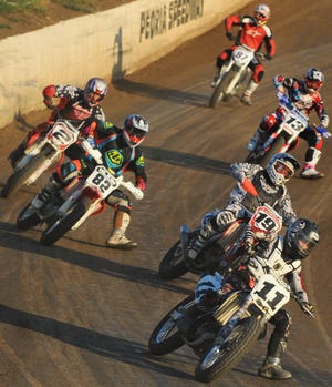 Motorcycles race around the Peoria Speedway track during one of the many heats during Friday's "Prelude to the Grand Nationals" AMA All-Star National Flat Track Series.