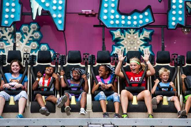 Kids scream as they are tossed in a circle on the Avalanche ride in the Midway at the Illinois State Fair, Friday, Aug. 10, 2012, in Springfield, Ill.