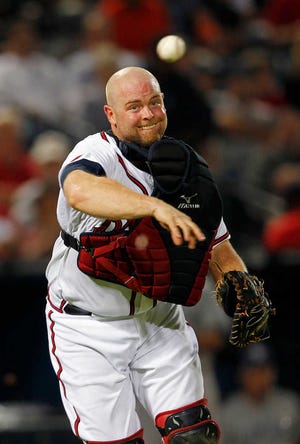Atlanta Braves catcher Brian McCann (16) throws to first after fielding a bunt during a baseball game against the San Diego Padres Monday, Aug. 13, 2012, in Atlanta,. (AP Photo/John Bazemore)