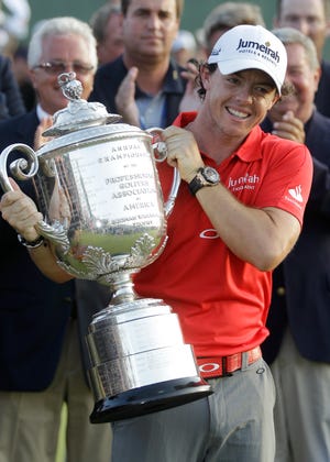 Rory McIlroy of Northern Ireland holds up the championship trophy after the final round of the PGA Championship golf tournament on the Ocean Course of the Kiawah Island Golf Resort in Kiawah Island, S.C., Sunday, Aug. 12, 2012.
