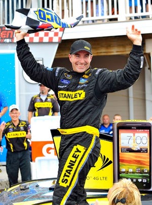 Marcos Ambrose celebrates in Victory Lane after winning the Sprint Cup Series Finger Lakes 355 at Watkins Glen International on Sunday.