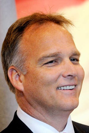 Georgia head football coach Mark Richt cracks a smile while speaking with a member of the media during the 11th Annual Peach State Pigskin Preview Tuesday, June 12, 2012, at the Georgia Sports Hall of Fame in Macon, Ga. (AP Photo/The Telegraph, Jason Vorhees)