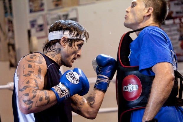 Paul Spadafora, left, works out with trainer Tom Yankello at the World Class Boxing gym in Ambridge on Tuesday, August 14, 2012.