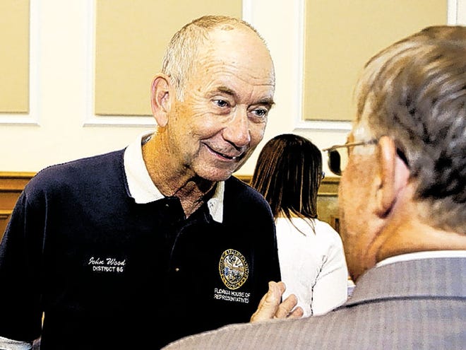 (L-R) John Wood, candidate Florida House of Representatives, talks with Allen Smith, from Winter Haven, at the historic courthouse in Bartow, Florida August 14, 2012.
