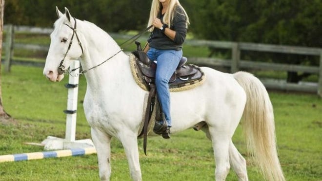 ‘There were several people interested in the ranch, but they were all developers who wanted to bulldoze the property and turn it into houses,’ Sandi Johnson, seen here with her Tennessee Walking Horse, Casper, says of her competitors to buy the Burt Reynolds Ranch in Jupiter Farms. ‘The county decided that wasn’t what they wanted for the community.’