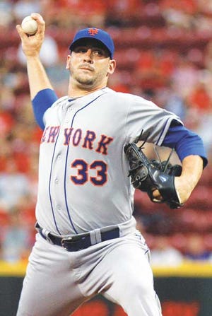 AP Photo/David Kohl — Mets starter Matt Harvey throws against the Cincinnati Reds in the first inning Thursday in Cincinnati.