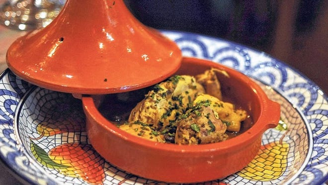 Served in the traditional chimney-inspired ceramic dish used to cook it, a tagine of chicken is moist and tender.