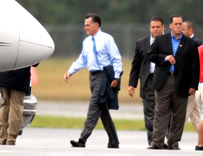 Republican presidential candidate Mitt Romney arrives at Barnstable Municipal Airport in Hyannis on Saturday following a fundraiser on Martha's Vineyard.