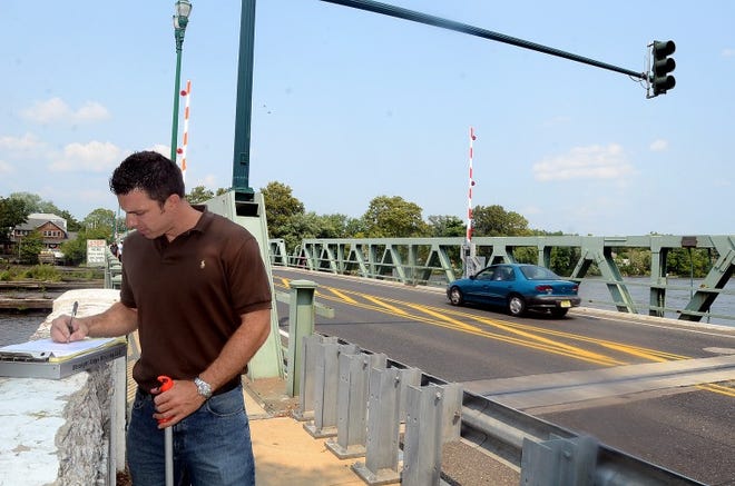 Robert Uveges, Project Estimator with Straight Edge Striping from Bound Brook goes over his measurements he took of the Riverside-Dlanco Bridge which will be closed next week for improvements.