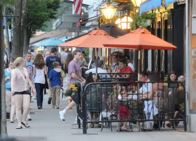 Diners enjoy outdoor seating at The Naked Oyster and British Beer Company on Main Street.