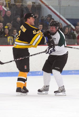 From left, Bruins Bruce Shoebottom and Abington's Alex Bezanson, mix it up. during the game between Boston Bruins alumni and Team Abington on Saturday, Jan. 14, 2012, at the Rockland Ice Arena.
