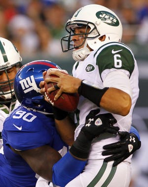 Giants defensive end Jason Pierre-Paul sacks Jets quarterback Mark Sanchez on Saturday during the first half.