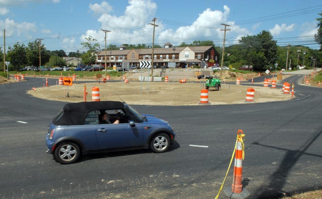 Cars go around the nearly completed rotary at Salem Four Corners.