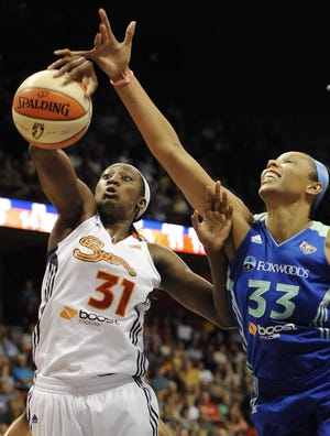 Connecticut’s Tina Charles, left, grabs a defensive rebound against New York’s Plenette Pierson on Saturday during the first half at Mohegan Sun Arena. Charles surpassed 1,000 rebounds for her career.