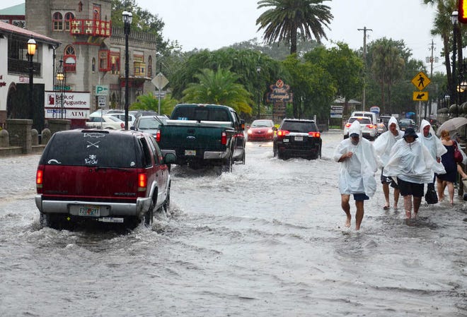 Cars and pedestrians make their way down a flooded King Street in St. Augustine on Tuesday, Aug. 21, 2012. By PETER WILLOTT, peter.willott@staugustine.com