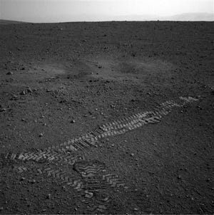 This image dated Wednesday Aug. 22, 2012 and provided by NASA shows the Curiosity rover's wheel tracks on the surface of Mars an image sent from one of the rover's cameras. The image was posted on a Tweet by JPL mission engineer Allen Chen.
