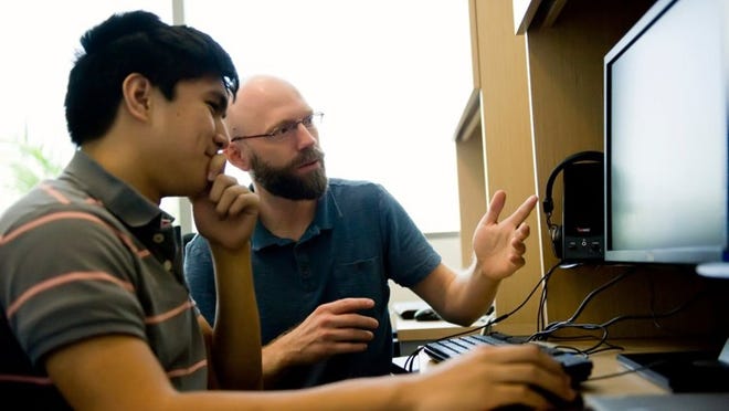 JUPITER — High school intern Terrell Ibanez, left, works with James Schummers of the Max Planck Florida Institute. The Suncoast High senior spent six weeks in the Cellular Organization of Cortical Circuit Function lab, which studies the functional organization of the cortex, responsible for many brain functions. (Photo provided)