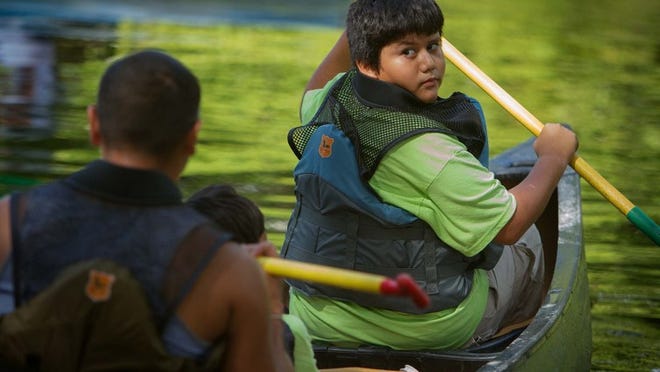 The Sierra Club’s Inner City Outings program in association with The Caridad Clinic hosted a canoe trip for children at Riverbend Park in Jupiter. Omar Alcocer, 13, of Royal Palm Beach, readied himself at the canoe launch for the day’s trip. (Thomas Cordy/The Palm Beach Post)