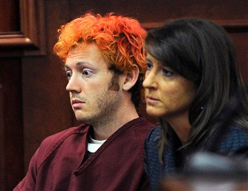 In this Monday, July 23, 2012 file photo, James Holmes, accused of killing 12 people in Friday's shooting rampage in an Aurora, Colo., movie theater, appears in Arapahoe County District Court with defense attorney Tamara Brady in Centennial, Colo. Colorado prosecutors are filing formal charges Monday July 30, 2012, against Holmes, the former neuroscience student accused of killing 12 people and wounding 58 others at an Aurora movie theater. (AP Photo/Denver Post, RJ Sangosti, Pool, File)