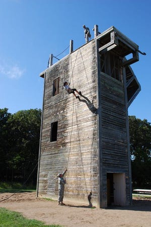 SFC Dennis Manning from Recruiting and Retention and SSG Gowen from the 191st Military Police Company assist students from the Lake Region State College through the rappel tower on August 17 at the Camp Grafton Training Center.