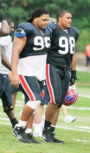 Dwan Edwards walks with teammate Torell Troup during practice.